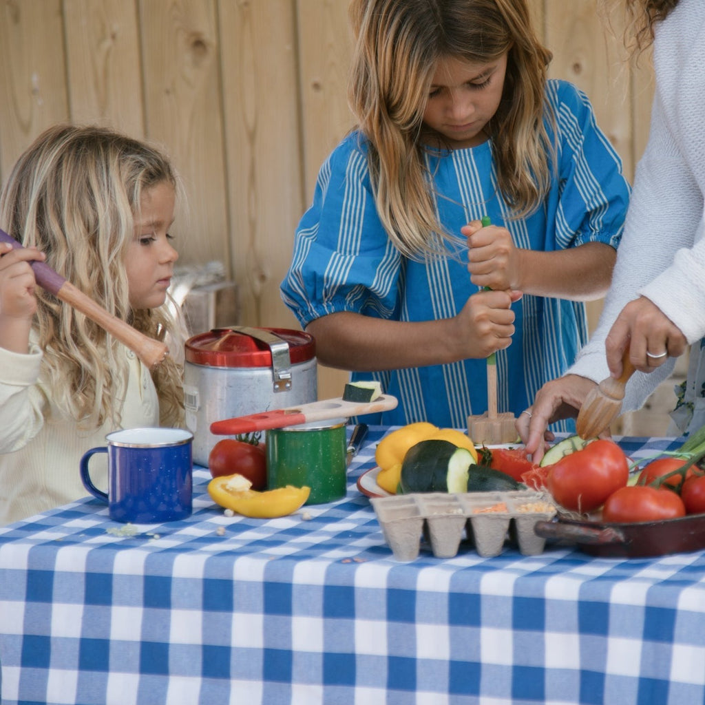 Family using NEW for 2024  Grapat fine motor tools being used on a table with vegetables