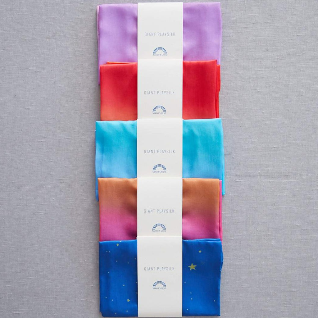 Sarah's Silks - giant play silks all displayed in rainbow colours folded