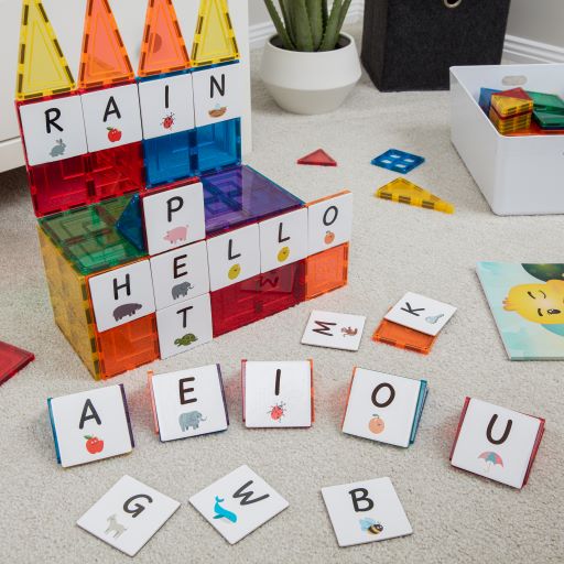 Alphabet upper case tile toppers to use with magnetic tiles shown sitting on the floor 