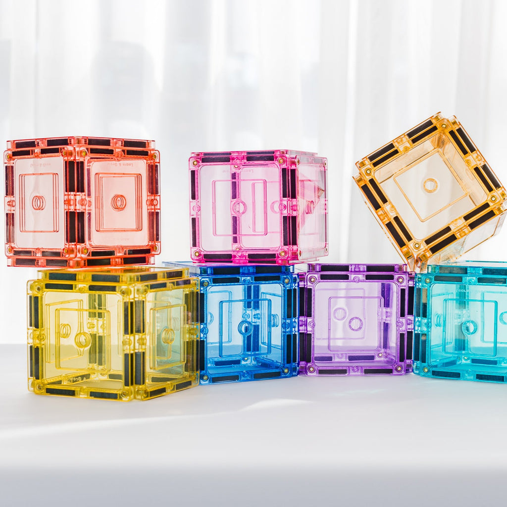 Colourful transparentm pastel magnetic tiles built as  cubes on a white background
