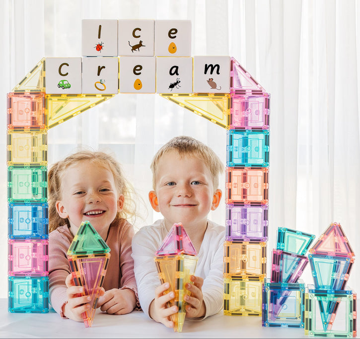 Two children with colourful ice cream-themed building blocks.