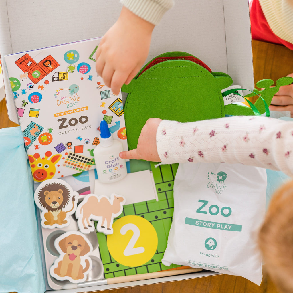 Kids pointing at all the things inside the mini explorer zoo box from My Creative Box