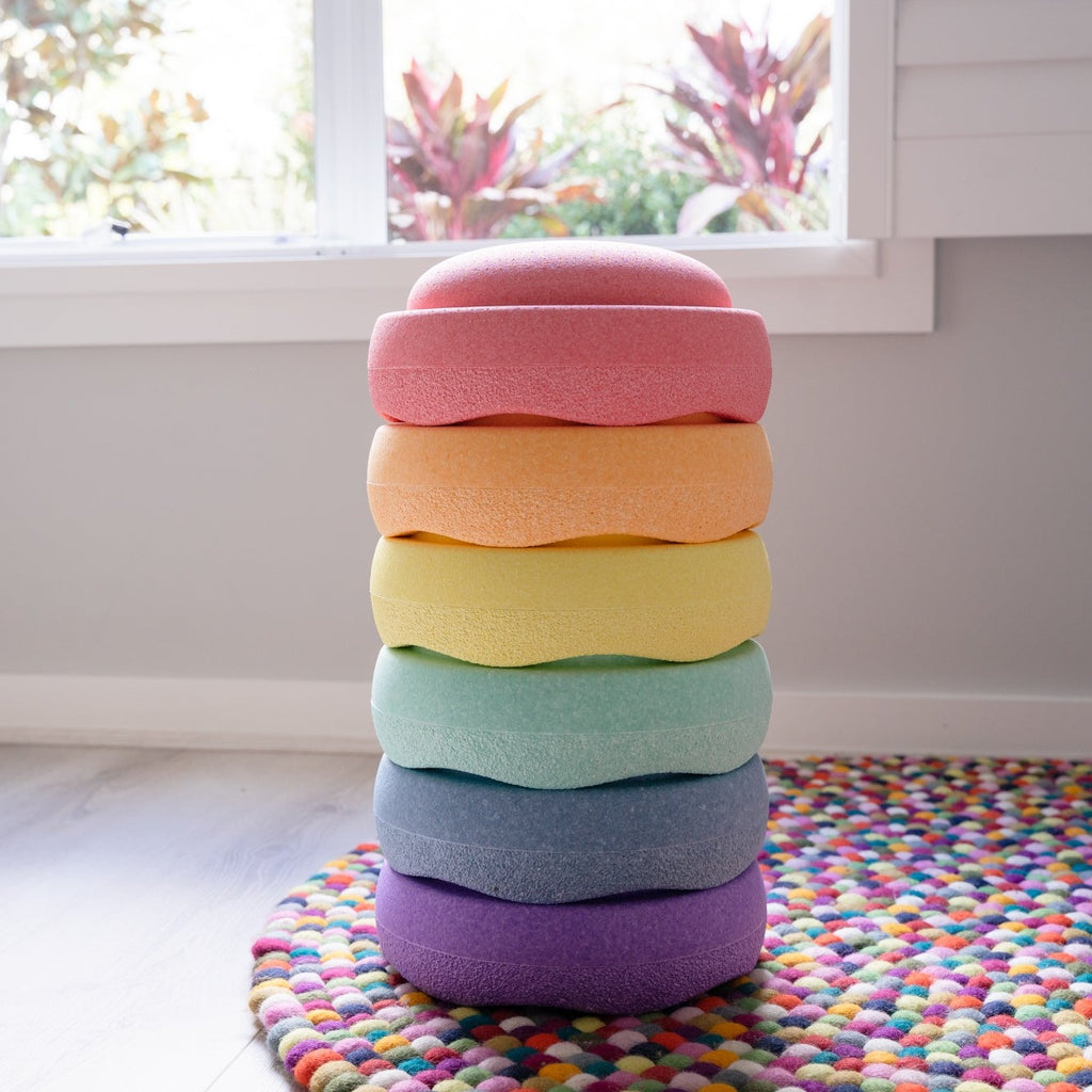 Pastel stapelstein stacked on rainbow rug