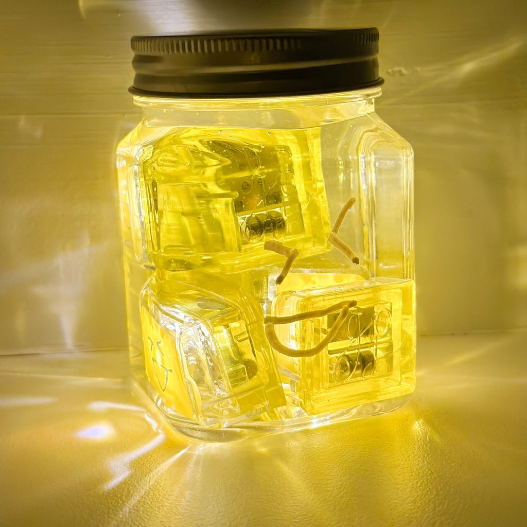 Yellow glo pals in mason jar lit up