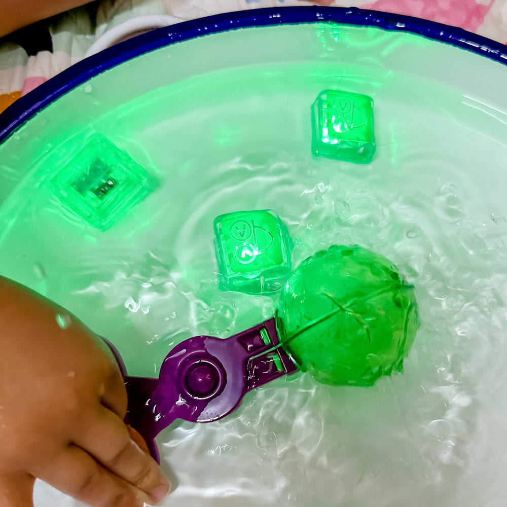 Handy scooper being used in water to pick up glo pal
