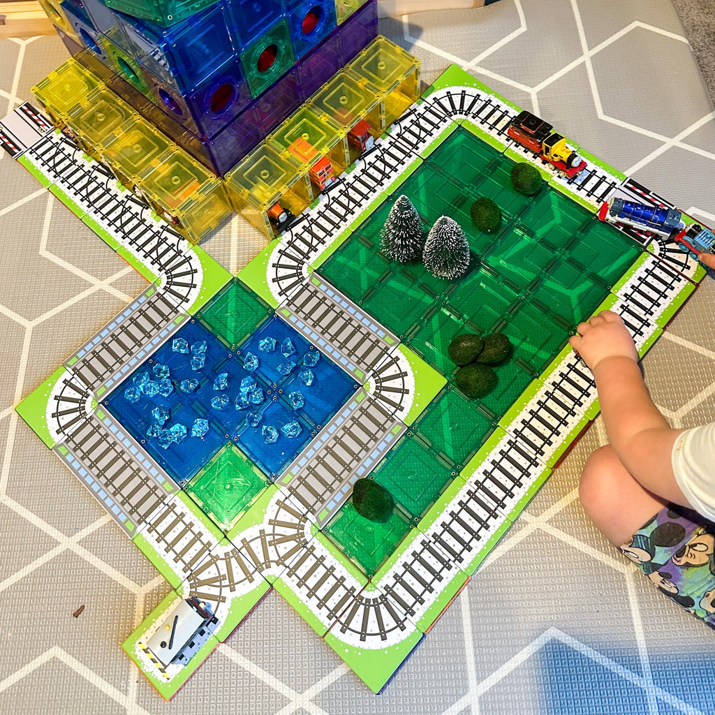 36 piece train toppers sitting on magnetic tiles with child playing using thomas trains
