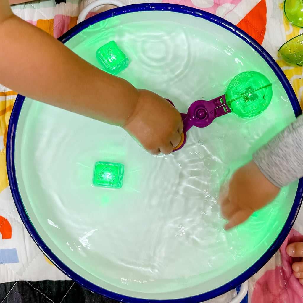 Handy scooper being used in water to pick up glo pal