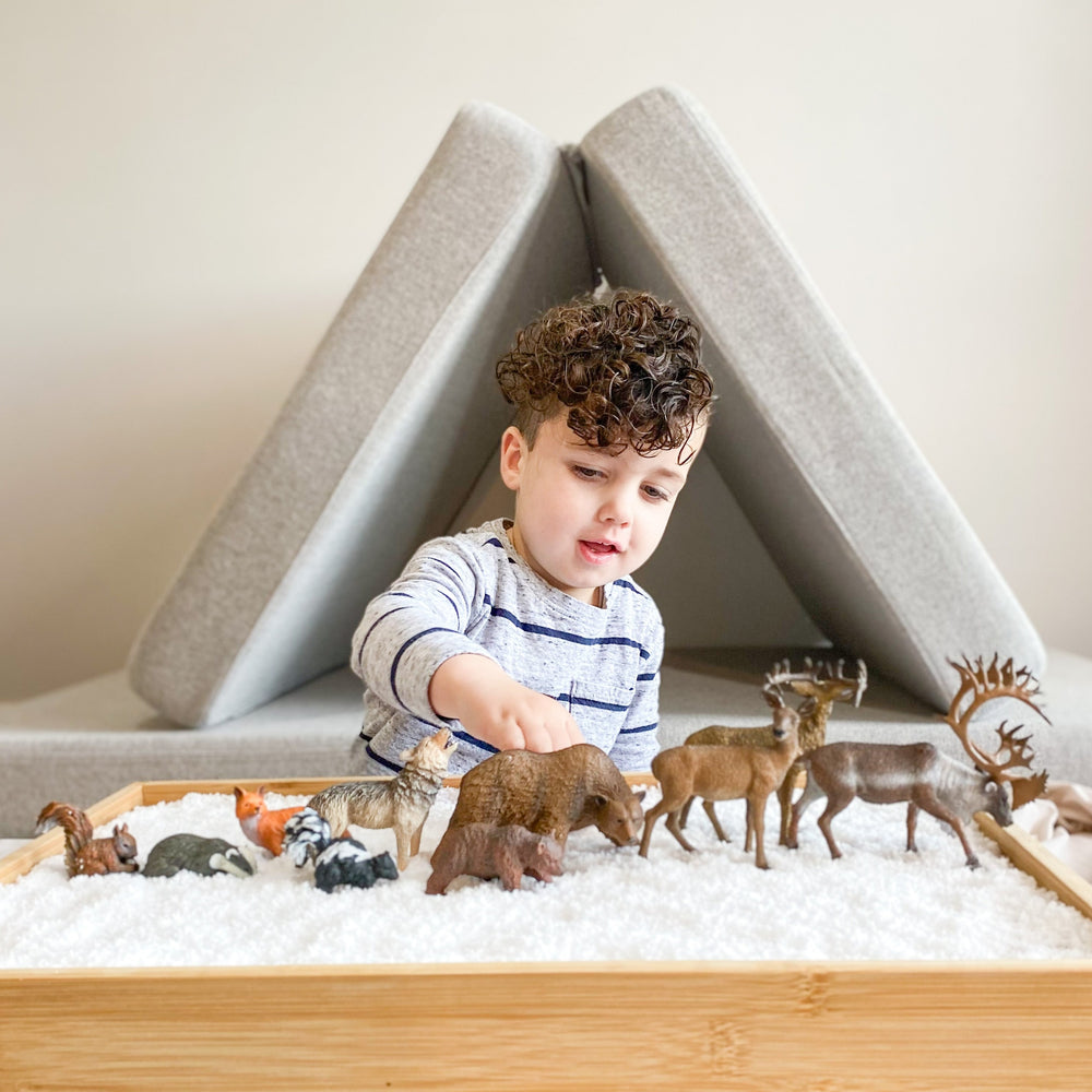 Child playing with 3 months worth of Woodland themed boxes