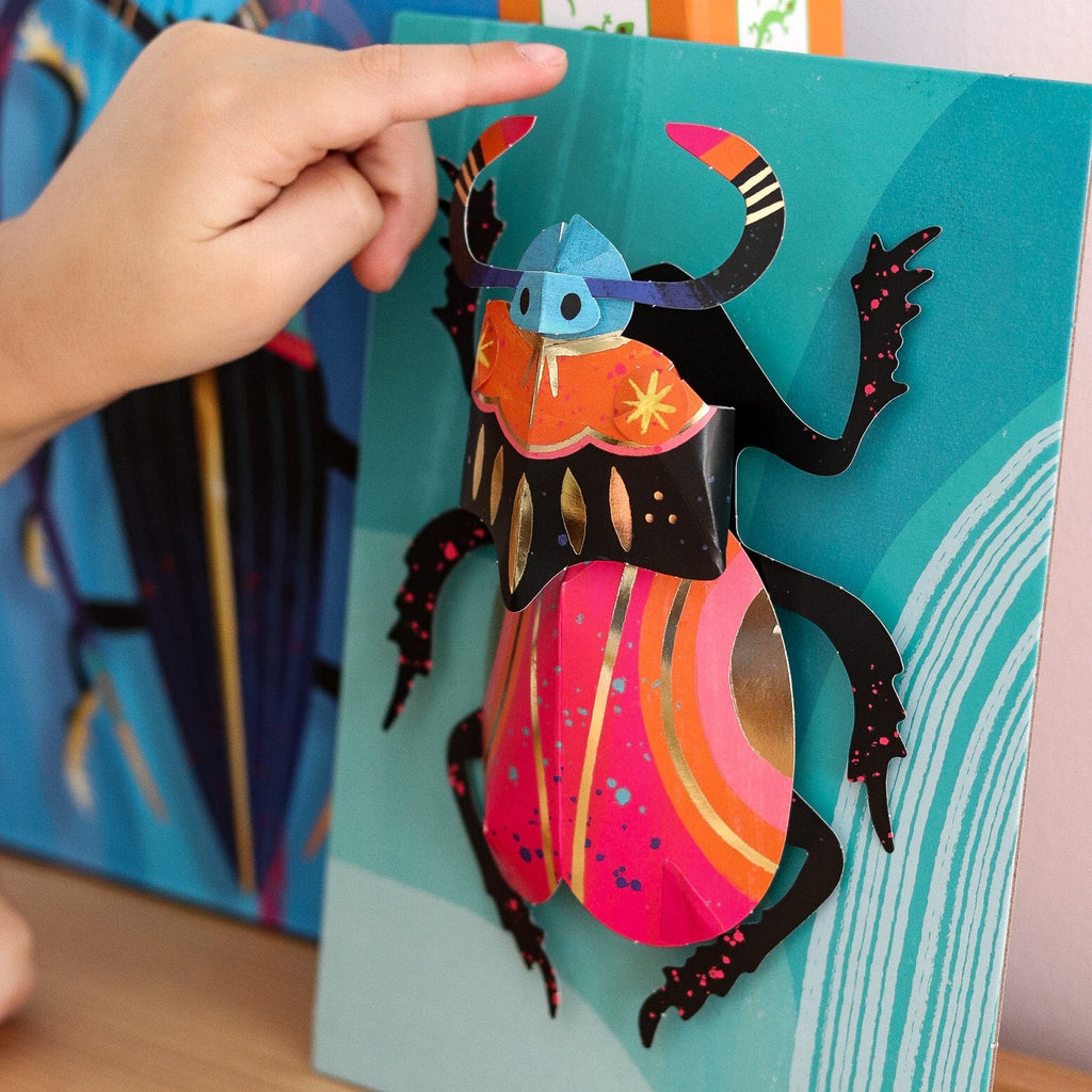 Child pointing 3d bug art from Djeco