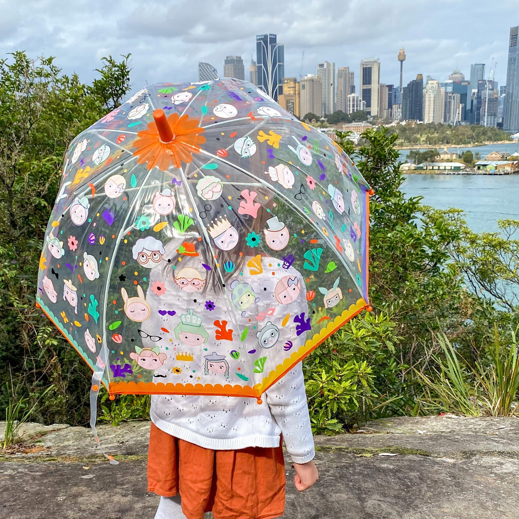 Colour changing pvs kids umbrella held by child looking at the sydney skyline