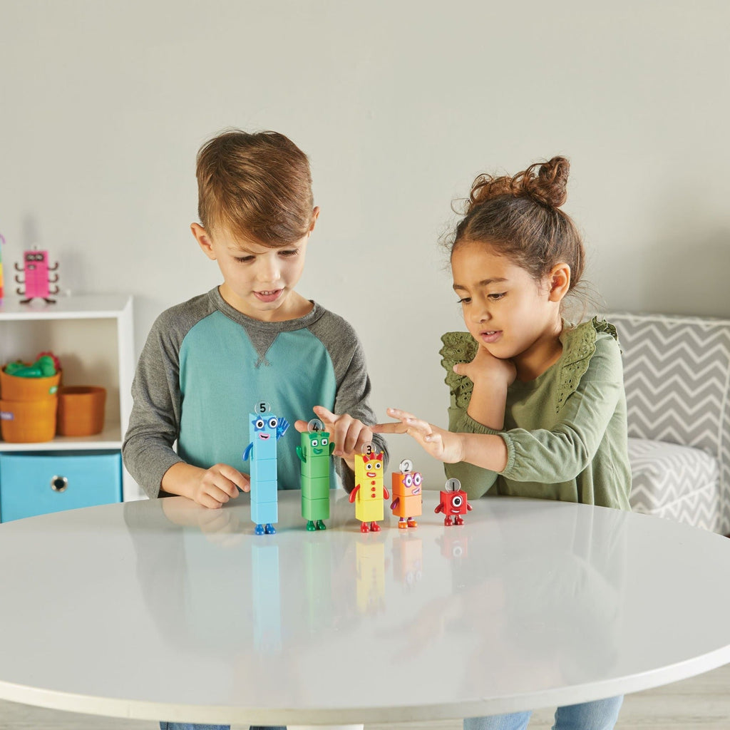 2 kids sitting at table playing with numberblocks friends one to 5