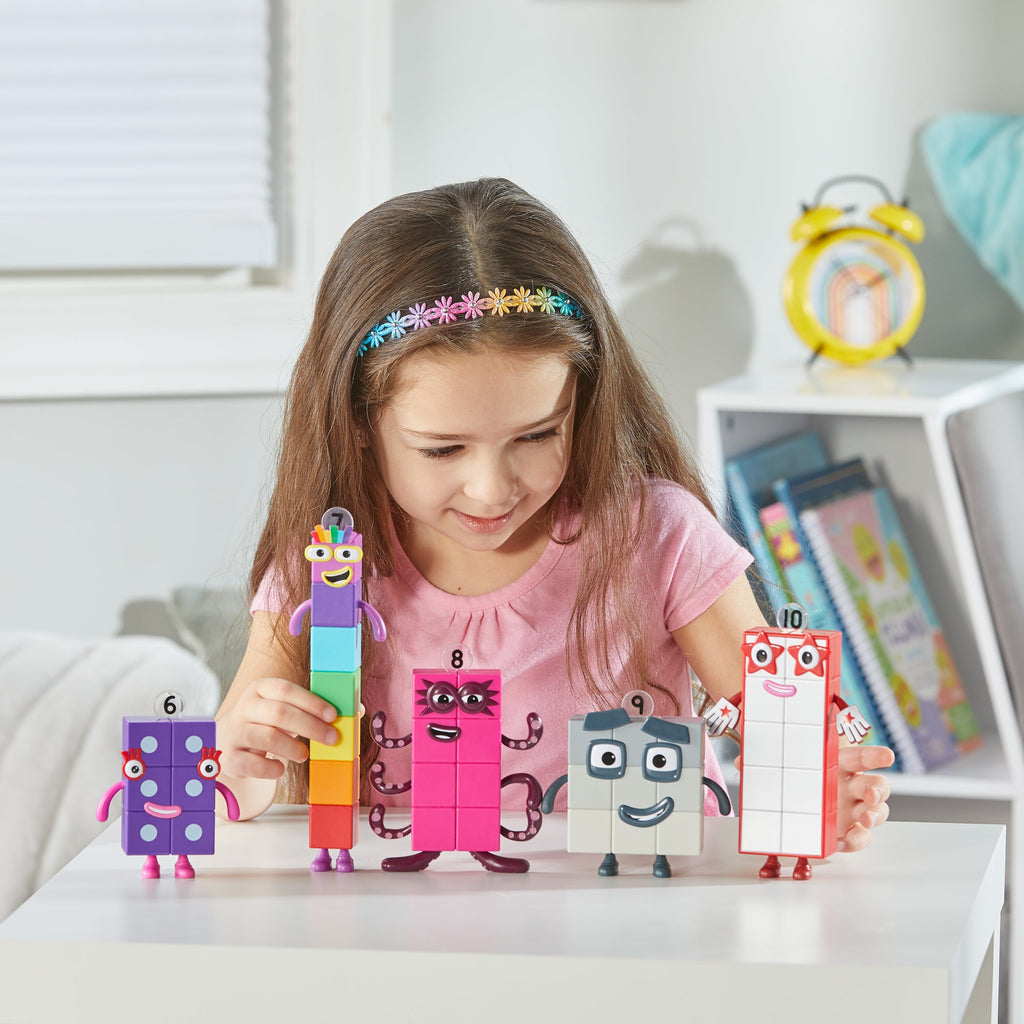 Girl playing with NUMBERBLOCKS® Friends Six to Ten toys on table