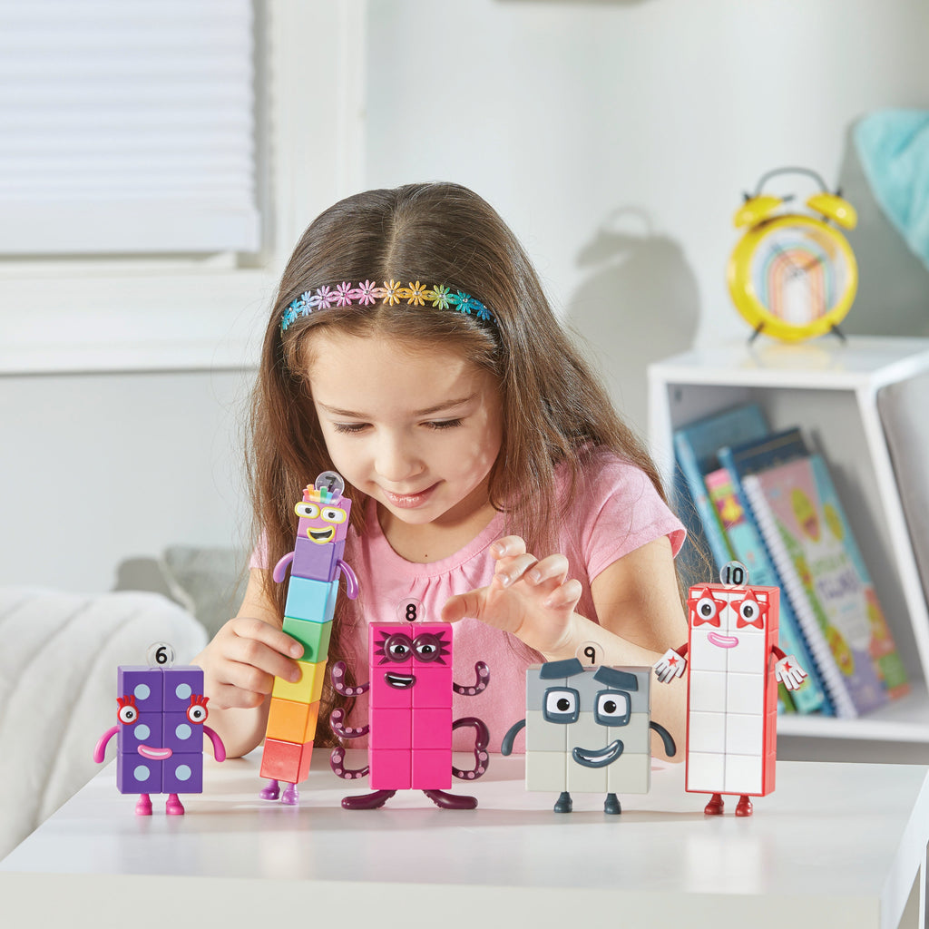 Girl playing with NUMBERBLOCKS® Friends Six to Ten toys on table