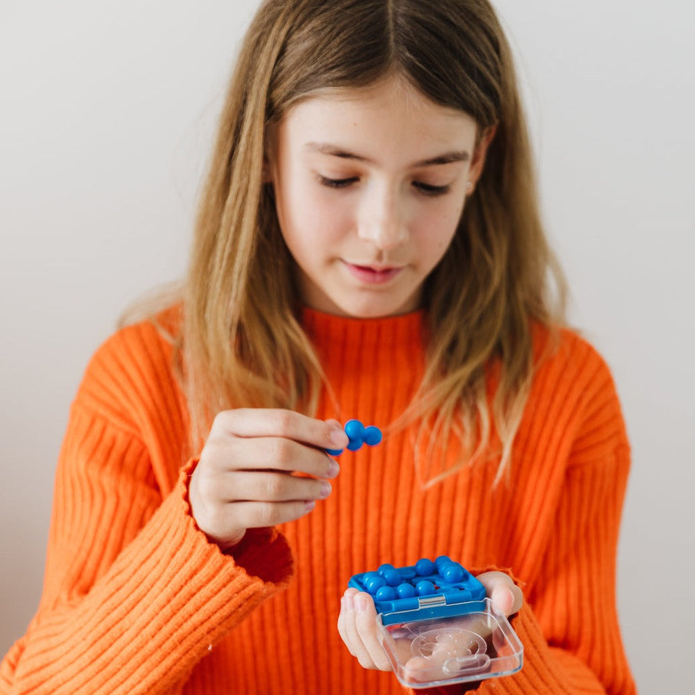 Girl playing with blue IQ Mini game