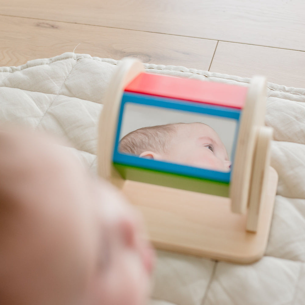 Baby reflection showing in mirror of The Spinning drum