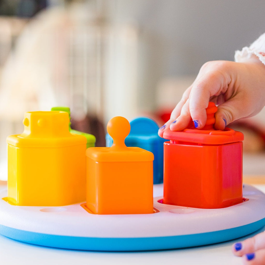 Child playing with colourful shape sorter
