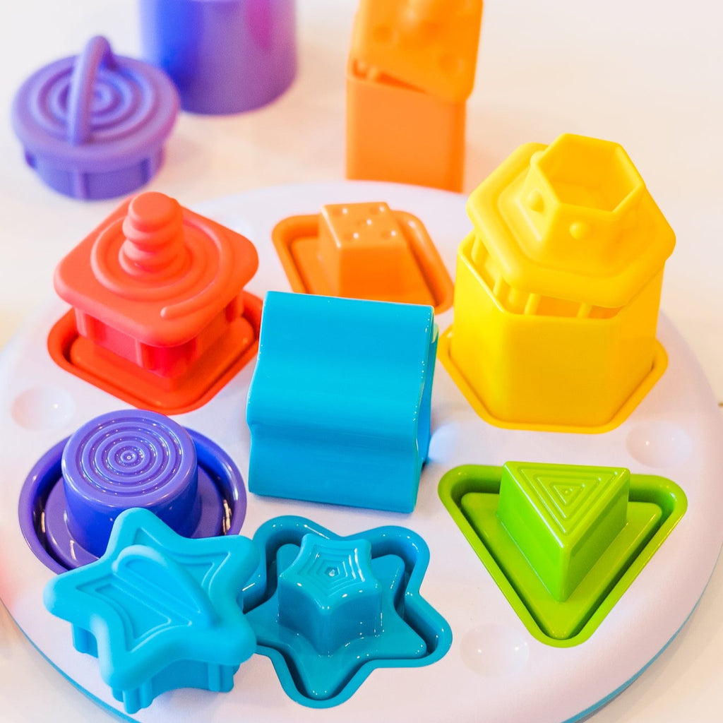 Colourful shape sorter with silicone plugs displayed on table