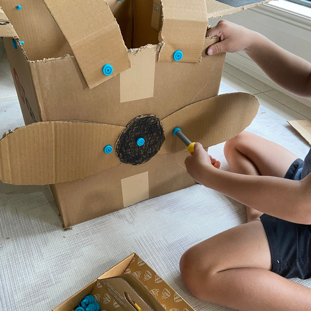 Child making plane using Makedo Explore Set 