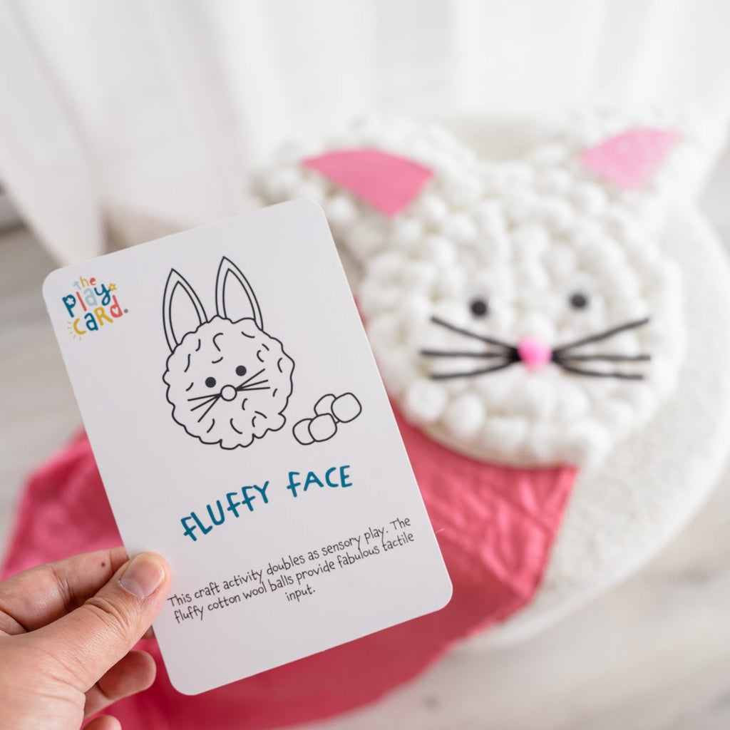 Fluffy Face card held in hand with fluffy face in background