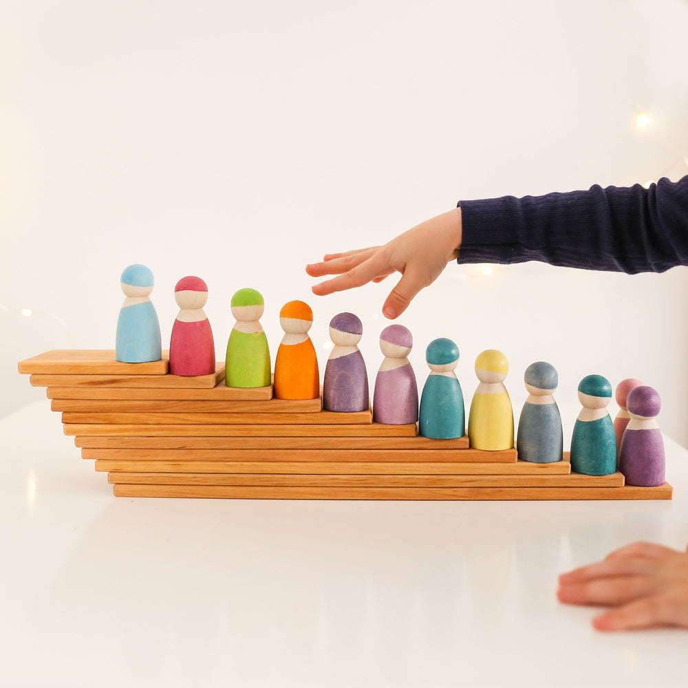 Rainbow pastel friends with Grimm's natural building boards played with by a child