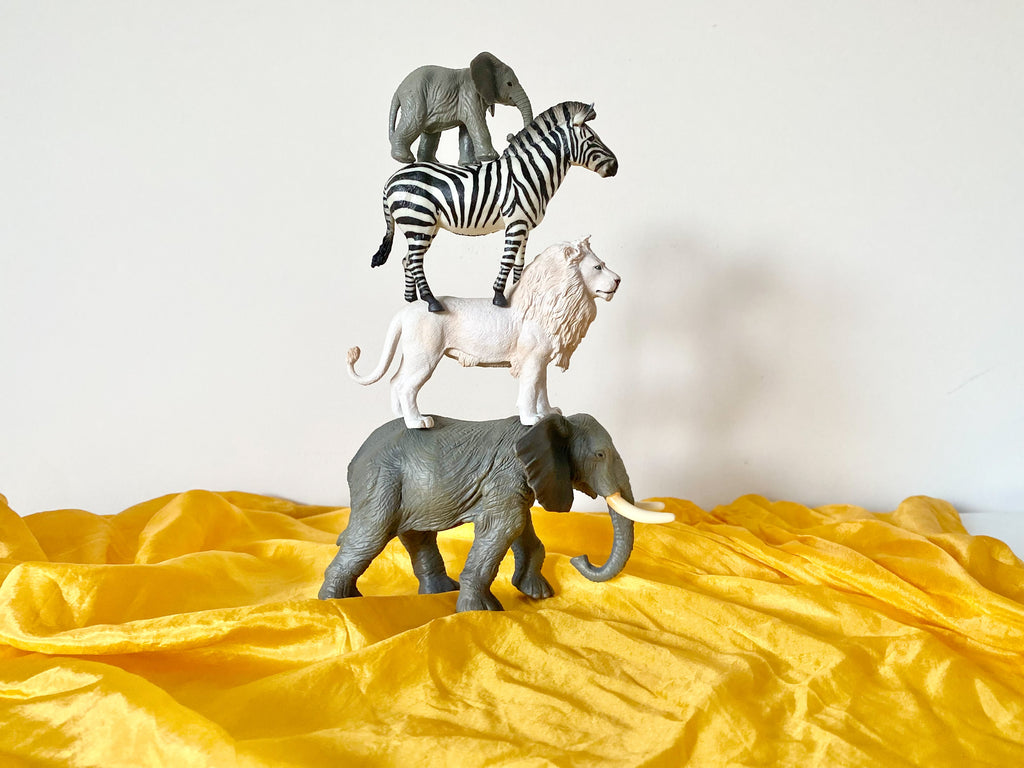 CollectA animals - white lion, zebra. elephants set up on yellow sarah's silk