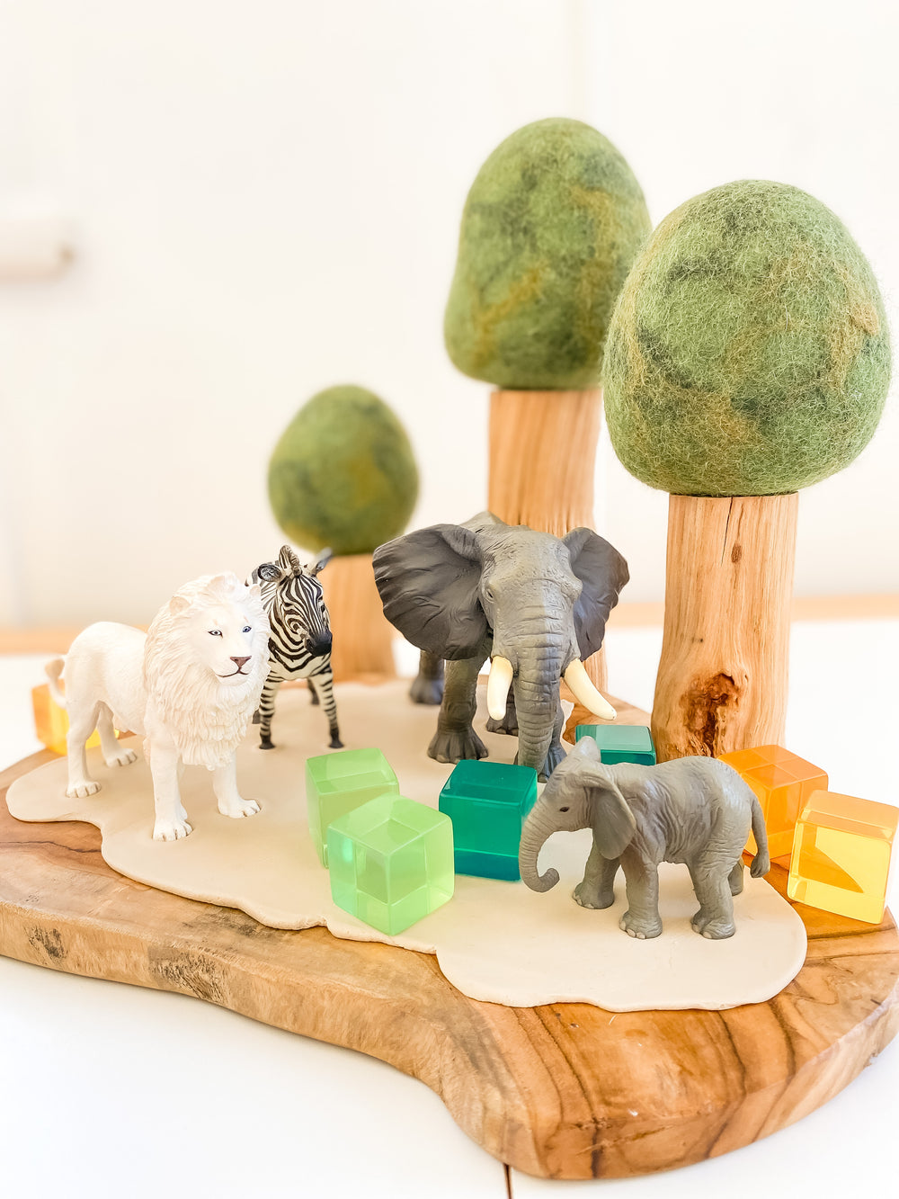 CollectA animals - white lion, zebra. elephants set up on wooden board with papoose trees and lucite cubes 