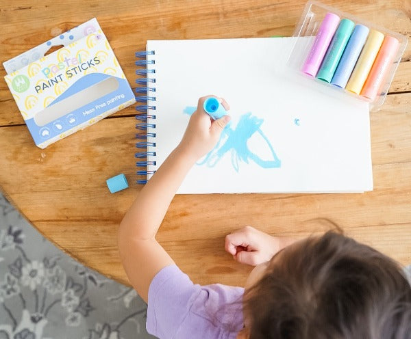 Child painting rainbow with Pastel Paint Sticks