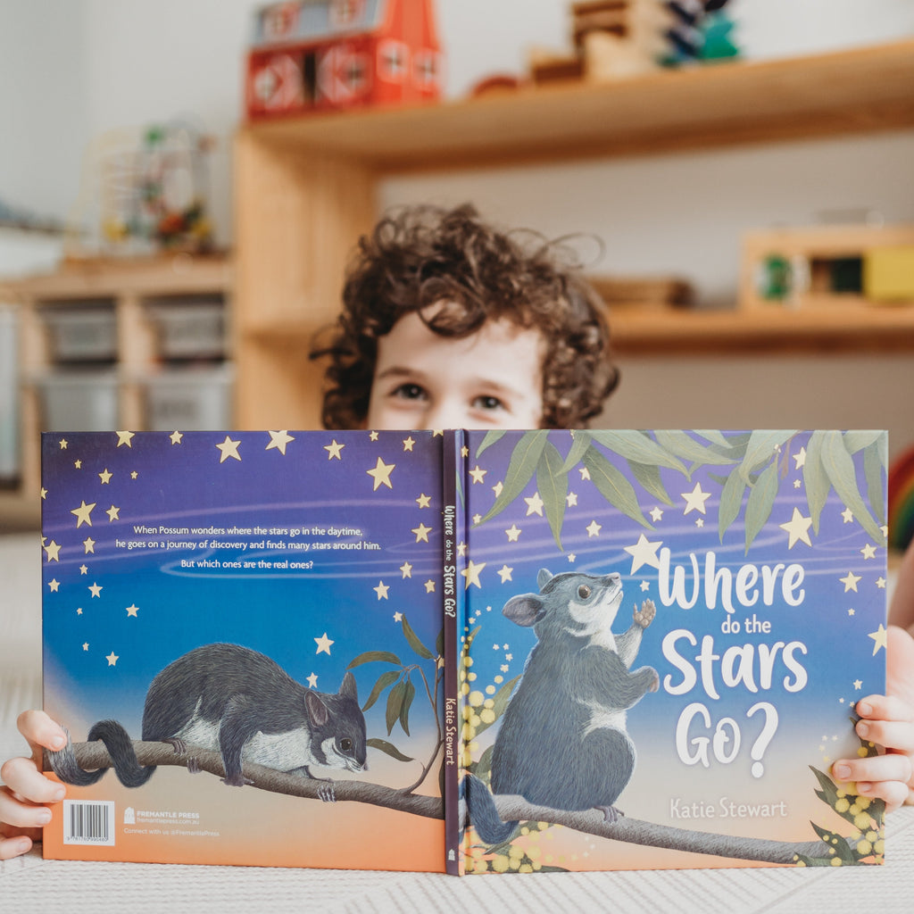 Child peeking over 3-5 years book Where do the stars go? 