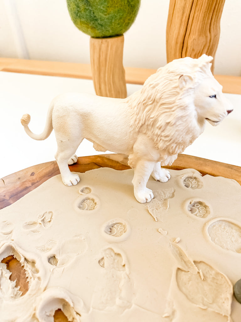 CollectA white lion on playdough with papoose tree in background