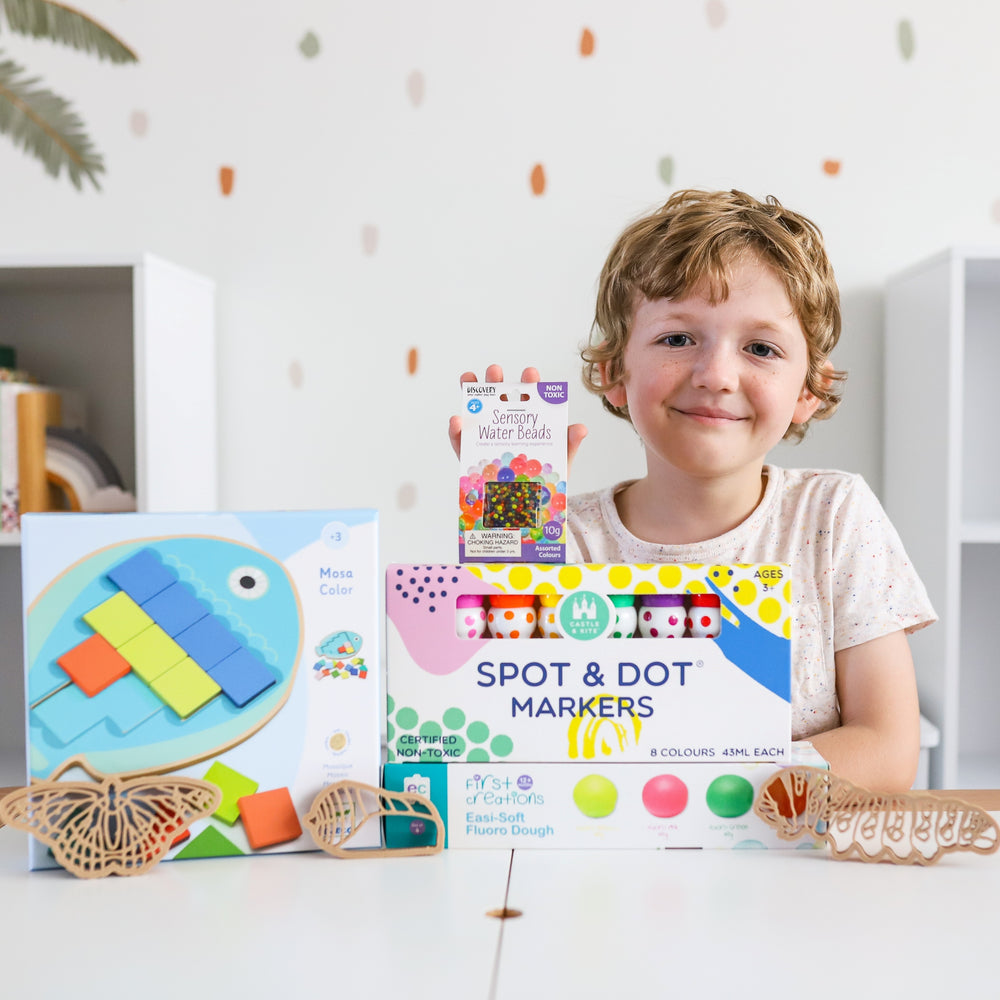 Child showing toys from February 2021 Play Subscription box