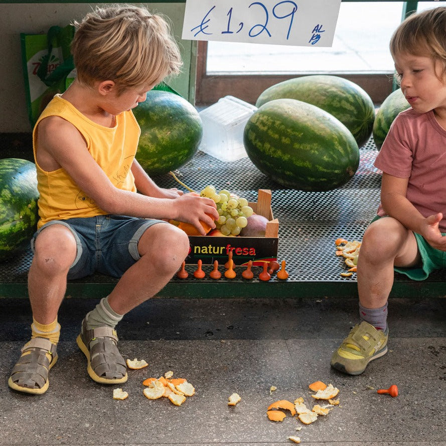 Children playing with Grapat Pumpkin Mandalas in a fruit shop