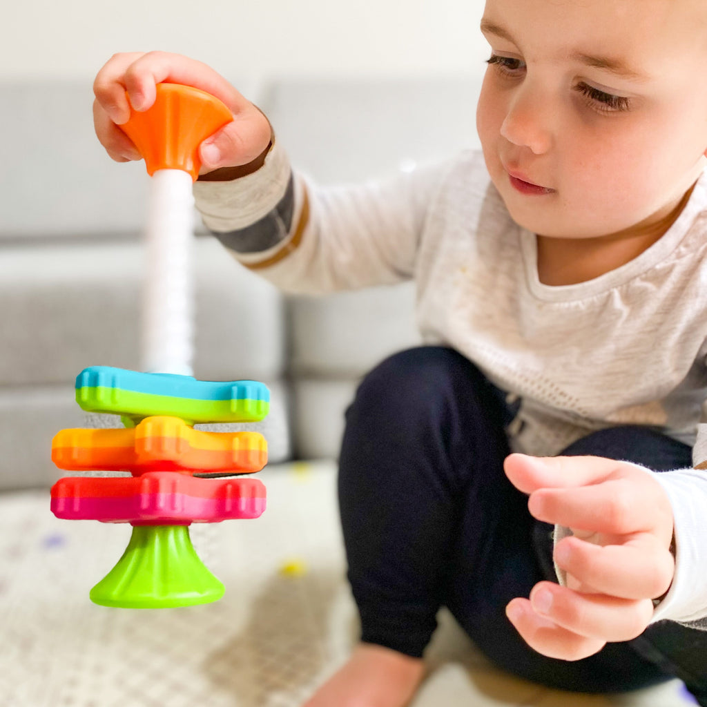 Fat Brain Toys - Mini Spinny being played with by a young child 