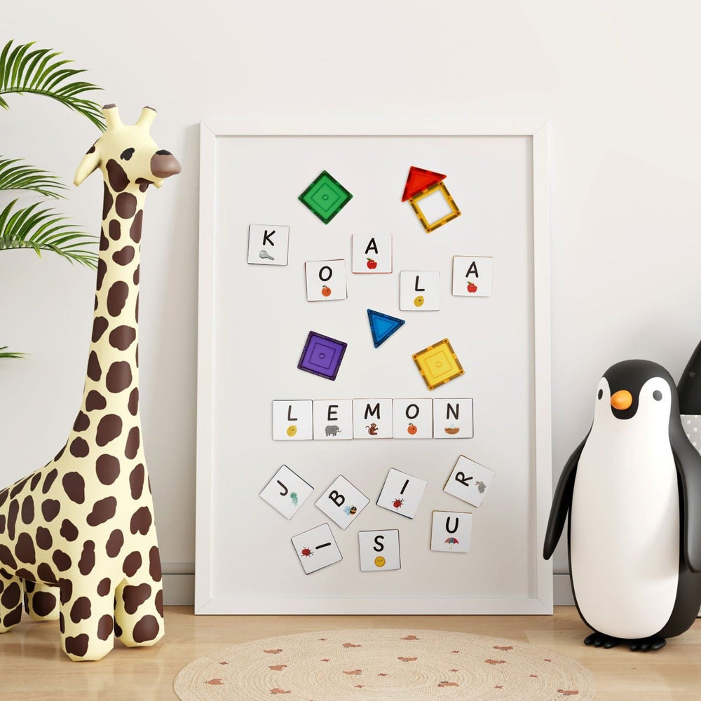 Alphabet upper case tile toppers to use with magnetic tiles shown on a framed whiteboard with toys in either side