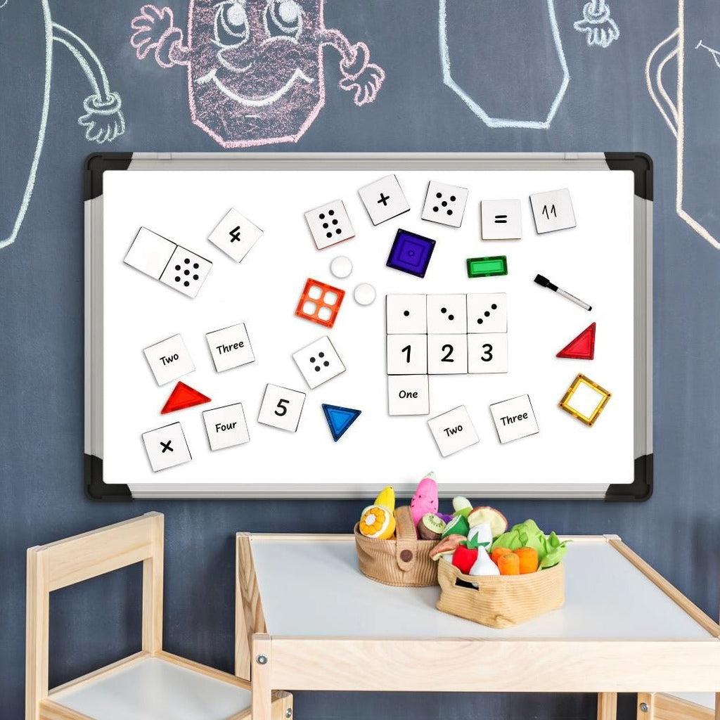 Numeric tile toppers to add to magnetic tiles displayed on a white board with a kids table in a playroom