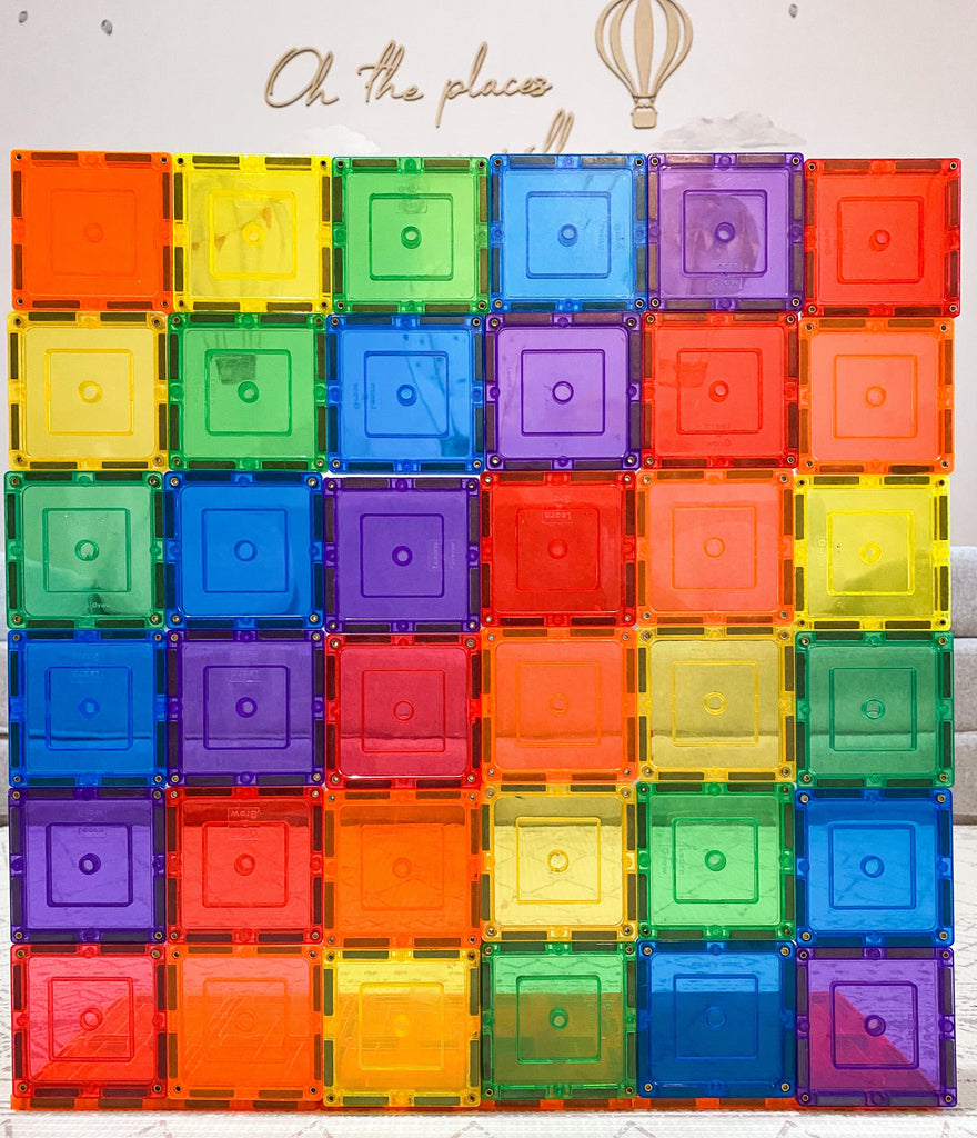 Rainbow coloured magnetic square tiles stacked 