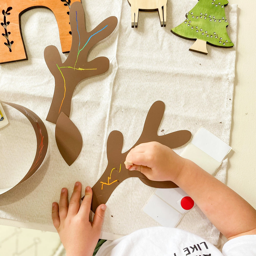 Child creating Scratch Art Reindeer Antlers 