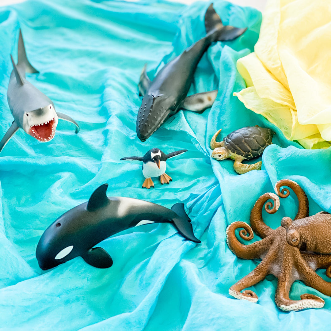CollectA ocean animals displayed against a blue and yellow Sarah's Silk