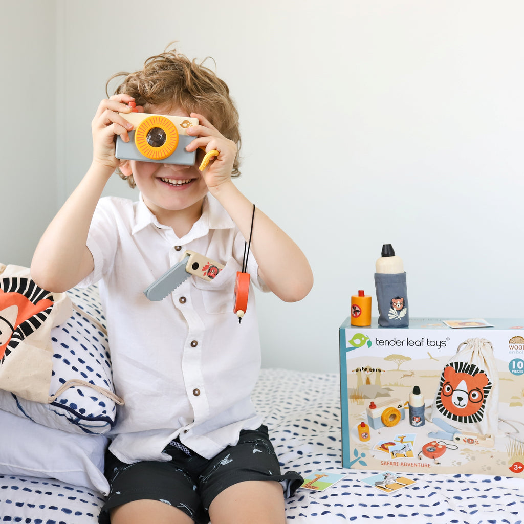 Child playing with wooden toy camera from August 2021 Play Subscription box
