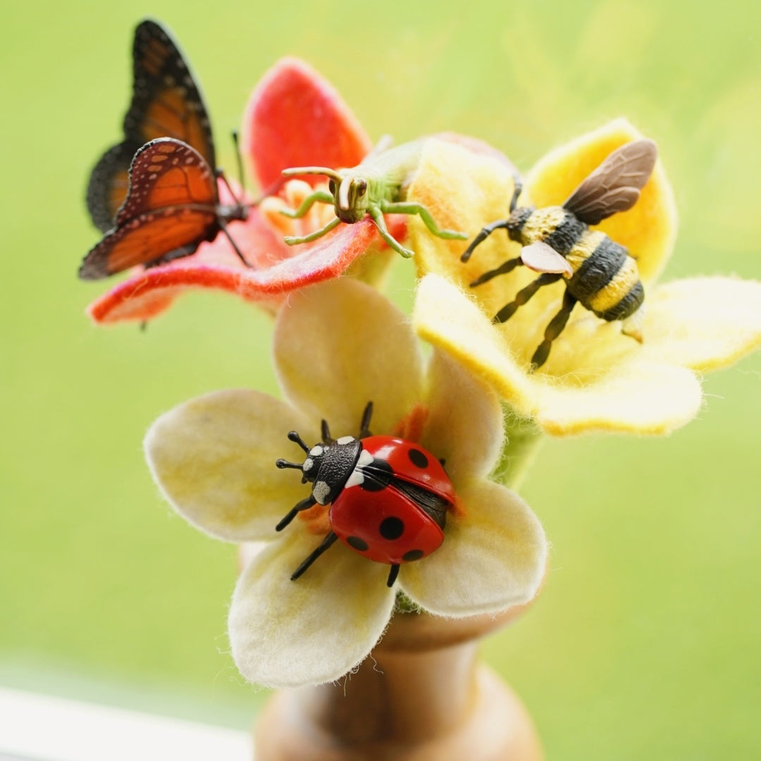 Insects and butterfly collecta on felt flowers